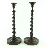 A pair of mahogany barley twist stem candlesticks, circa 1920's, bronze bobeches, dished circular