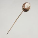 A late 19th century yellow metal, shell cameo stick pin, depicting Diana