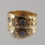 An Edwardian 18ct gold diamond and gem-set three-stone band ring