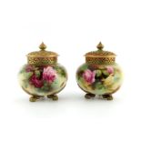 R Austin for Royal Worcester, a pair of rose painted potpourri vases and covers