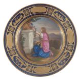 A late 19th Century Vienna cabinet plate, painted with Cordelia kneeling at an altar, jewelled and