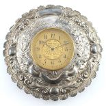 A Victorian embossed silver wall clock, Charles Edwards, London 1887