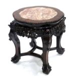 A 19th Century Chinese hardwood low stand, inset veined pink marble top, fretwork carved base,