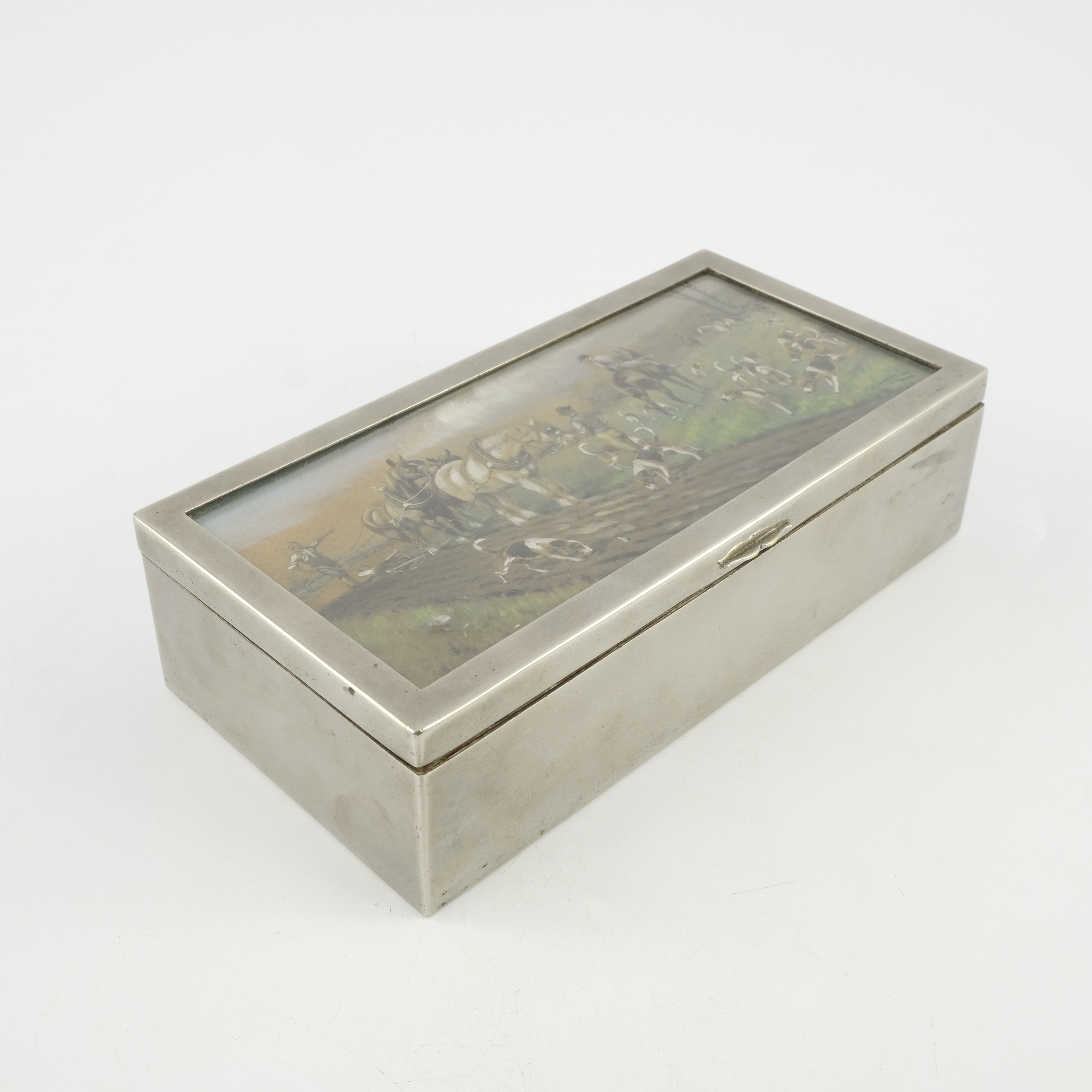 An Edwardian electroplated table cigarette casket of hunting interest, the cover with an inset