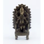 An Indian cast brass figure of a four armed deity, elephant mask, seated on a throne, height 21cm