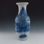 A 19th Century Chinese provincial blue and white baluster vase, painted with a mountainous river