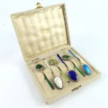 David Andersen, a harlequin set of six Norwegian silver gilt and enamelled coffee spoons