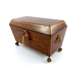 A Regency mahogany tea caddy, circa 1820, of sarcophagus form, parquetry inlaid and strung
