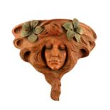 An Art Nouveau terracotta wall bracket