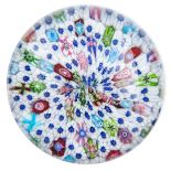 Clichy, a close packed irregular millefiori piedouche glass paperweight