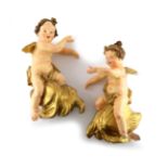 A pair of carved wooden and gesso winged cherubs, probably from an Italian altar, mid 18th