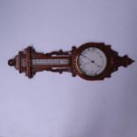 A late Victorian aneroid barometer, circa 1890, carved oak case with scrollwork, thermometer over