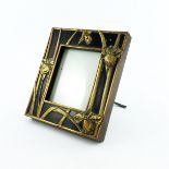 An Art Nouveau easel photograph frame, circa 1905, of rectangular form with fretwork brass