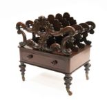 A mid Victorian rosewood canterbury, circa 1860, triple scroll divisions, single frieze drawer