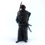 A Japanese bronze study of a Samurai, 20th Century, modelled standing wearing a robe and holding two