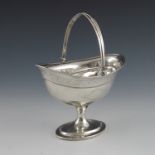 A George III Irish silver sugar basket, Dublin 1799, bright cut decorated pedestal boat form with sw