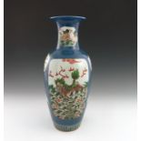 A 19th Century Chinese baluster vase, decorated with polychrome panels of fish, landscapes,