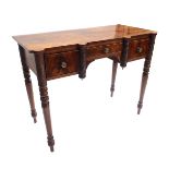 A Regency mahogany writing table, circa 1820, triple frieze drawers flanked by ring turned pilasters