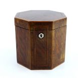 A George III mahogany tea caddy box, circa 1790, of octagonal form, crossbanded and strung