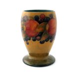 William Moorcroft, a Pomegranate vase, circa 1932, footed ovoid barrel form, orange ochre ground,