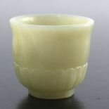 A Chinese carved jade cup, 3.7cm high