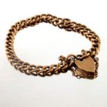 An early 20th century 9ct gold curb-link bracelet, with heart-shape padlock clasp