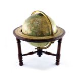 A George Philip 12 inch library table globe, circa 1920's, with eighteen applied coloured printed