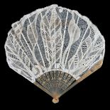 Circa 1900 to 1915, an unusual lace fan in fontange form, the monture of carved, pierced and lightly