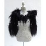 A 1920’s/30’s black ostrich feather shoulder cape, double-lined in black chiffon, length from neck t