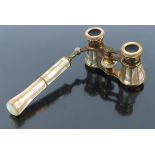 A pair of 19th century opera glasses with folding handle, in pink mother of pearl and gold metal, th