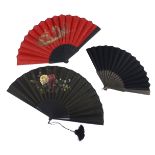 Three large fans c 1890 – 1900, the first with red glazed cotton leaf mounted on wood stained black,