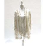 A circa 1900 Chinese cream silk crepe fringed cape, hip length, with two layers of macramé and silk