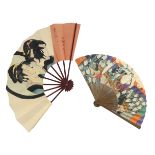 Two colourful Japanese paper fans, one showing a Geisha girl regarding herself in the mirror, white