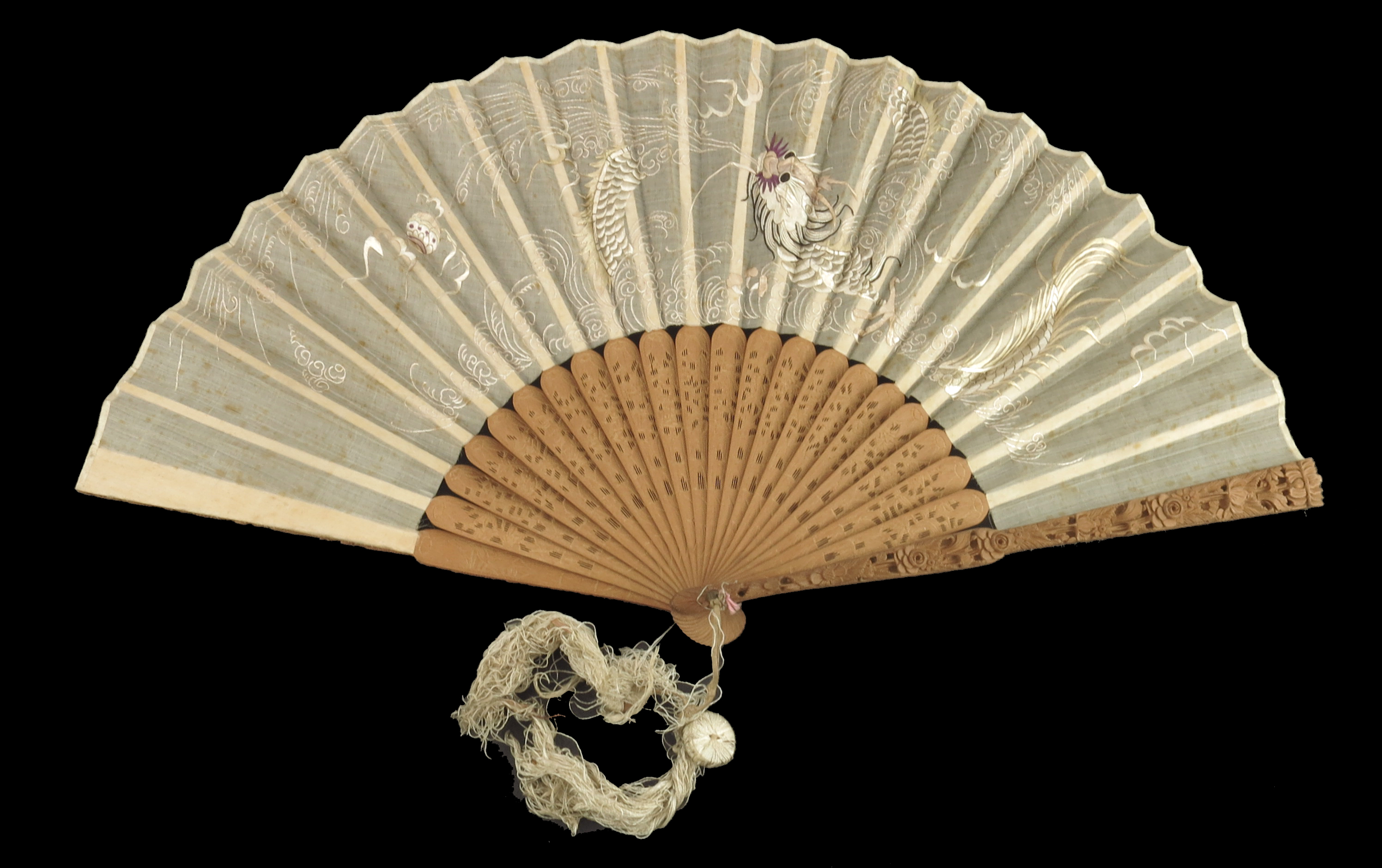 A 19th century Qing Dynasty Chinese fan with carved sandalwood monture, the guards both deeply carve