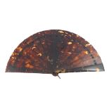 A simple tortoiseshell brisé fan, the guards and sticks wedge-shaped, fitted with a tortoiseshell lo