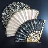 A c 1870/80’s wood fan, the monture painted gold, carved and pierced, the black Chantilly lace leaf