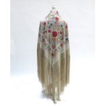 A cream silk Chinese Canton shawl embroidered throughout in polychrome, with medium to small flowers