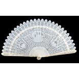 An early 19th century carved and pierced ivory brisé fan with 22 slender sticks, and two guards, the