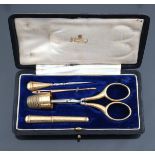 A French yellow metal sewing set in a simple black leather fitted case, French marks, the exterior l