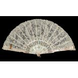 A late 19th century Brussels Point de Gaze needle lace fan, the pink Mother of Pearl carved, pierced