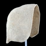 A very early whitework bonnet or cap, formed in 3 sections, all edges bound, the cap back slightly e