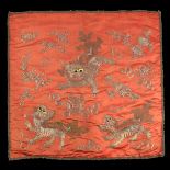 A deep terracotta Chinese silk panel, embroidered both sides in couched gold metal threads, with aus