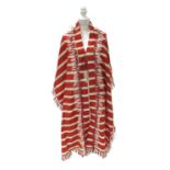 A Middle Eastern silk stole or shawl 19th/20th century, formed as a long cape with weighted tassel a