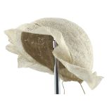 A very early whitework bonnet or cap, stiffened, and with pleated detail to the rear, formed in thre