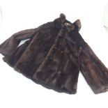 A vintage dark mink hip length jacket, unlabeled, worn by the vendor’s aunt in the 1960’s, lined in