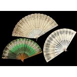 Three decorative fans from 1900 to the 1920’s, including an emerald green silk fan with inset cream