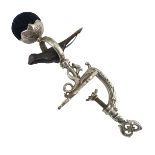 A large and ornate Victorian white metal sewing bird clamp, a blue velvet pin cushion fixed into a m