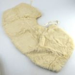 A vintage cream ermine shoulder cape, together with a knee length coat, possibly rabbit, a date labe