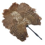 A shaped feather fixed fan or screen, a mix of brown and cream feather, possibly pheasant, the handl
