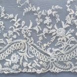 Antique Lace: A deep flounce of late 19th century Brussels bobbin appliqué, a floral design with spr